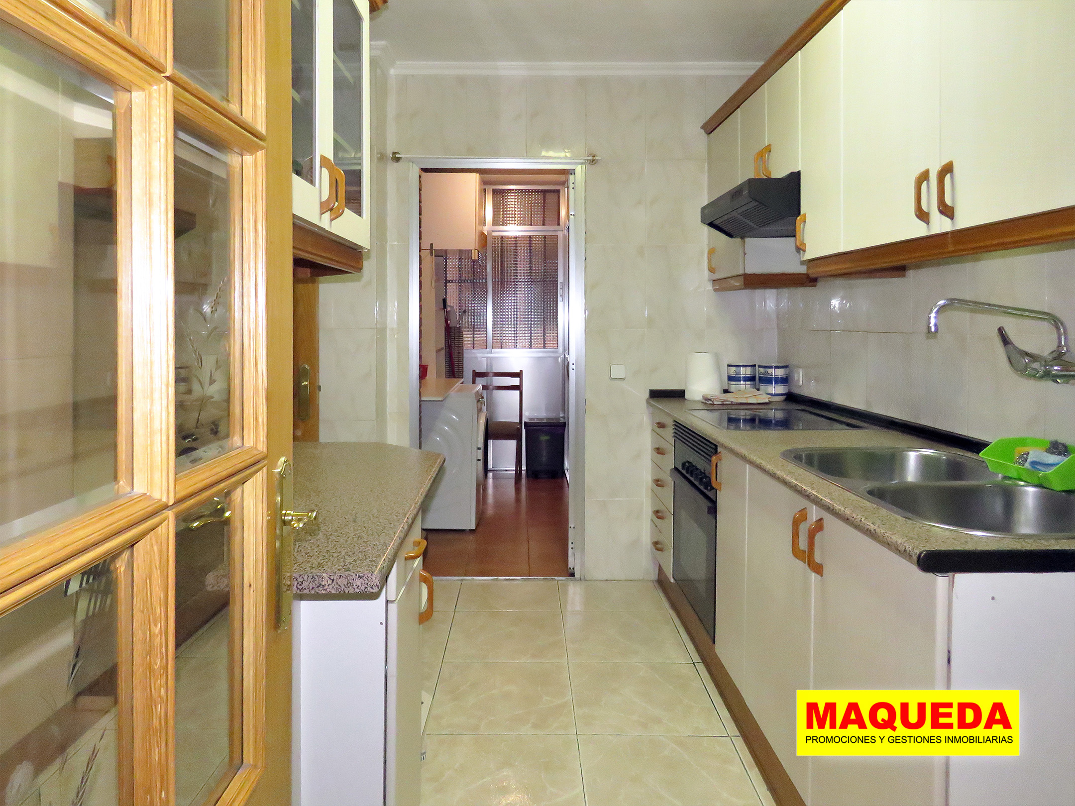 Cocina amueblada con tendedero acristalado al fondo