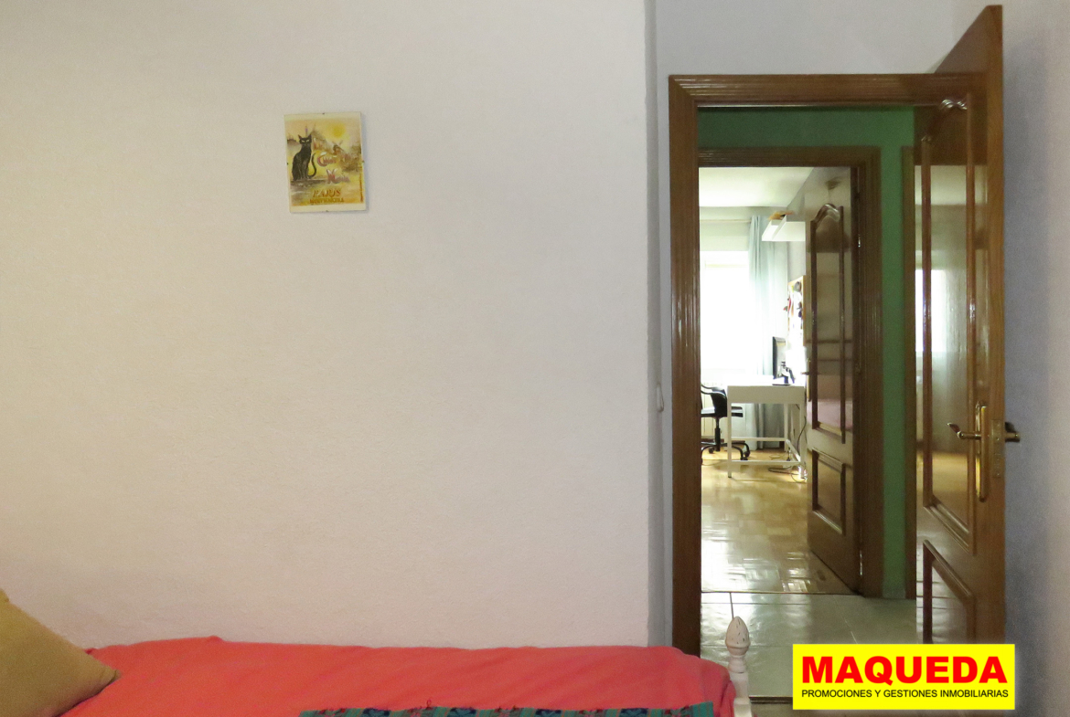 Dormitorio individual con pasillo de distribución al fondo