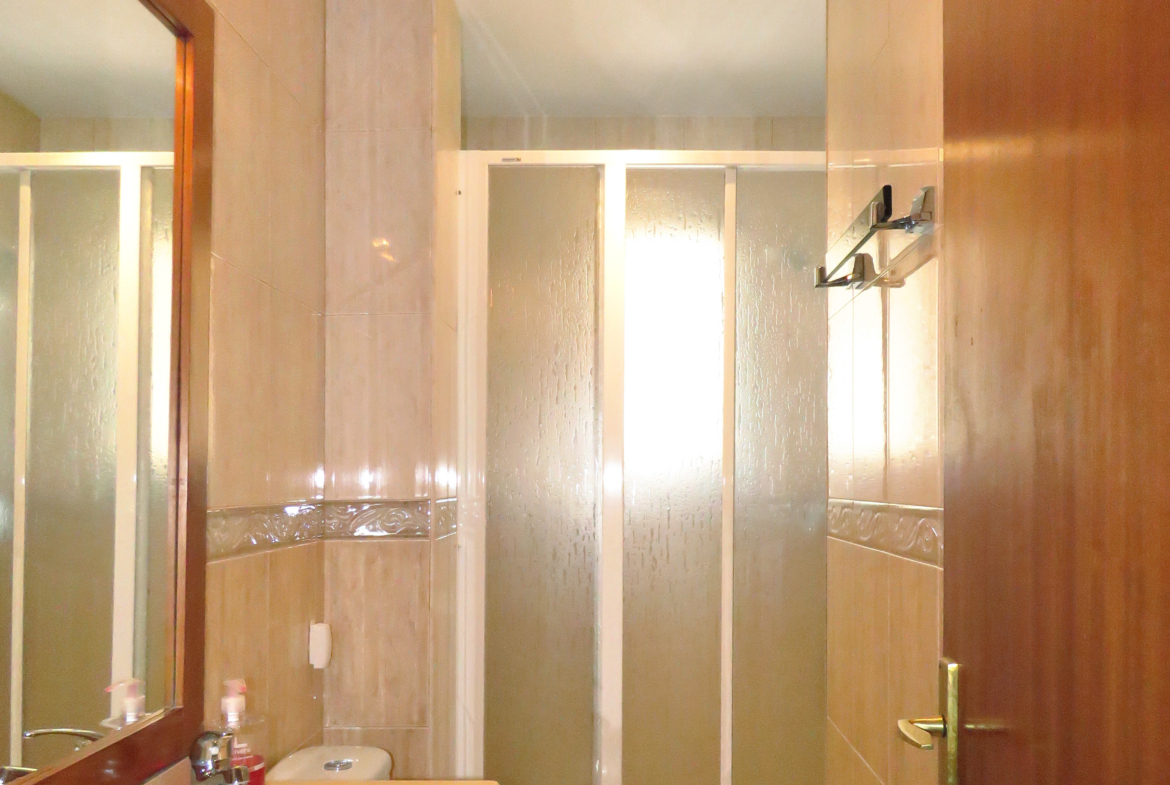 Cuarto de baño reformado con ducha y mampara