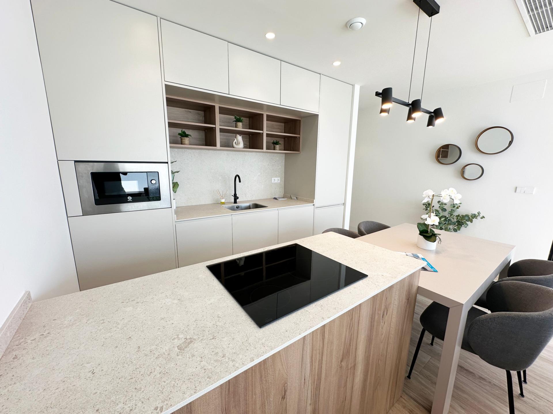 Contemporary kitchen with an island, built-in oven, white cabinets, and open wooden shelves above the sink.
