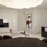 Open-plan living area with a beige sectional sofa, wall-mounted TV, and an abstract framed artwork near a modern kitchen island.