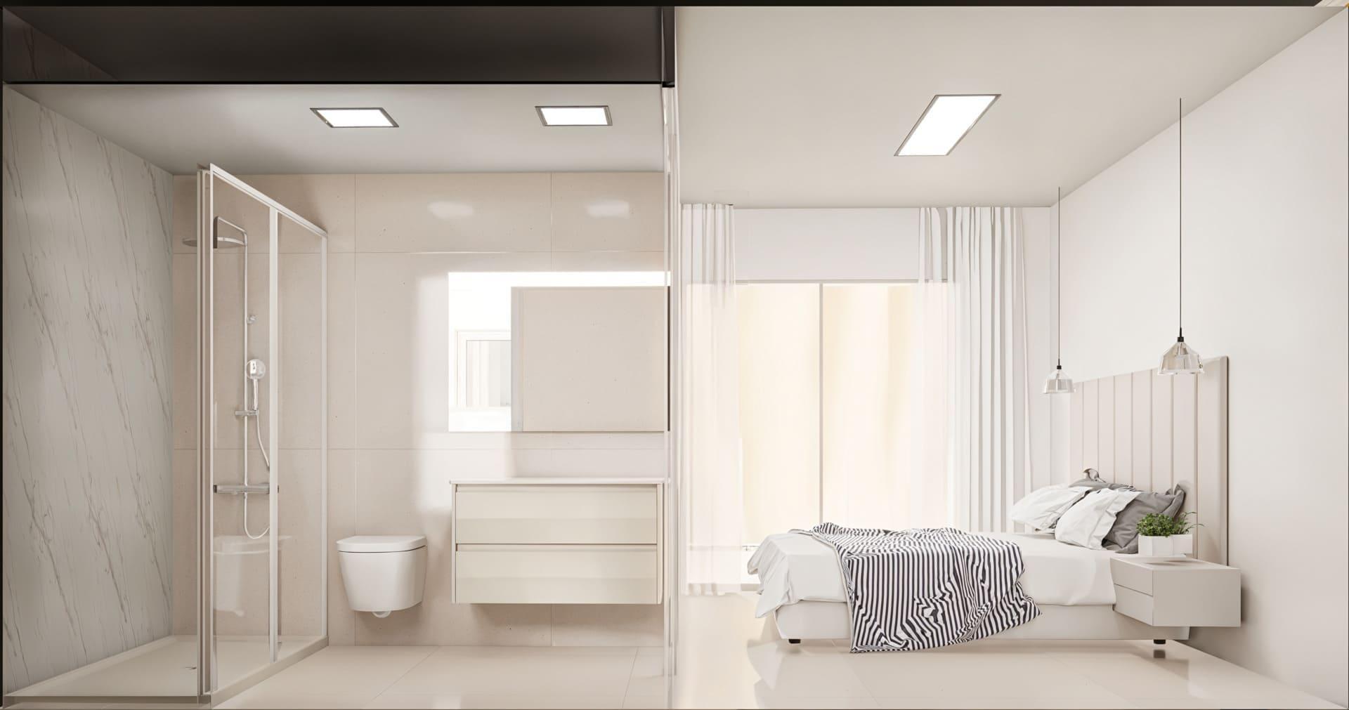 Modern white bedroom with a glass-walled bathroom visible on the left (shower, toilet, vanity) and a bed with striped bedding on the right.