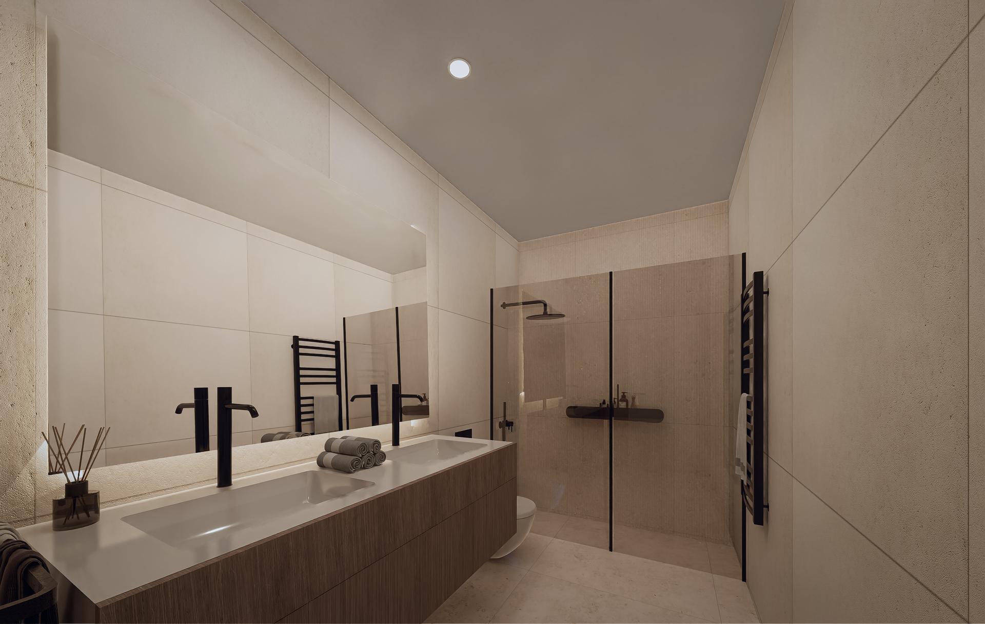 Modern bathroom with double sinks, a large mirror, and a glass-enclosed shower in neutral tones.