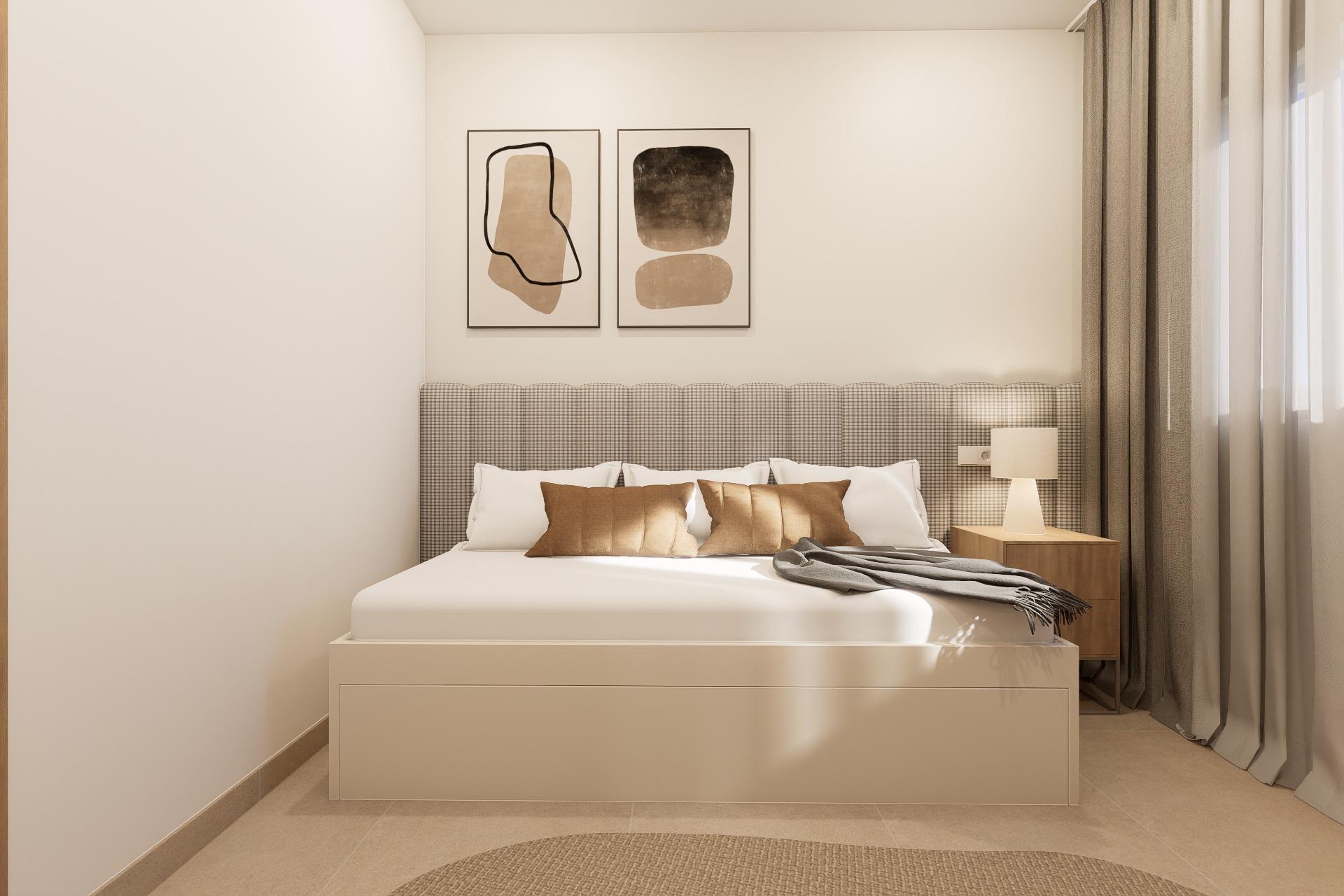 Neutral hotel-style bedroom with a beige platform bed, checkered headboard, two abstract framed prints above, white linens with brown pillows, a wooden nightstand and lamp, and floor-to-ceiling curtains.