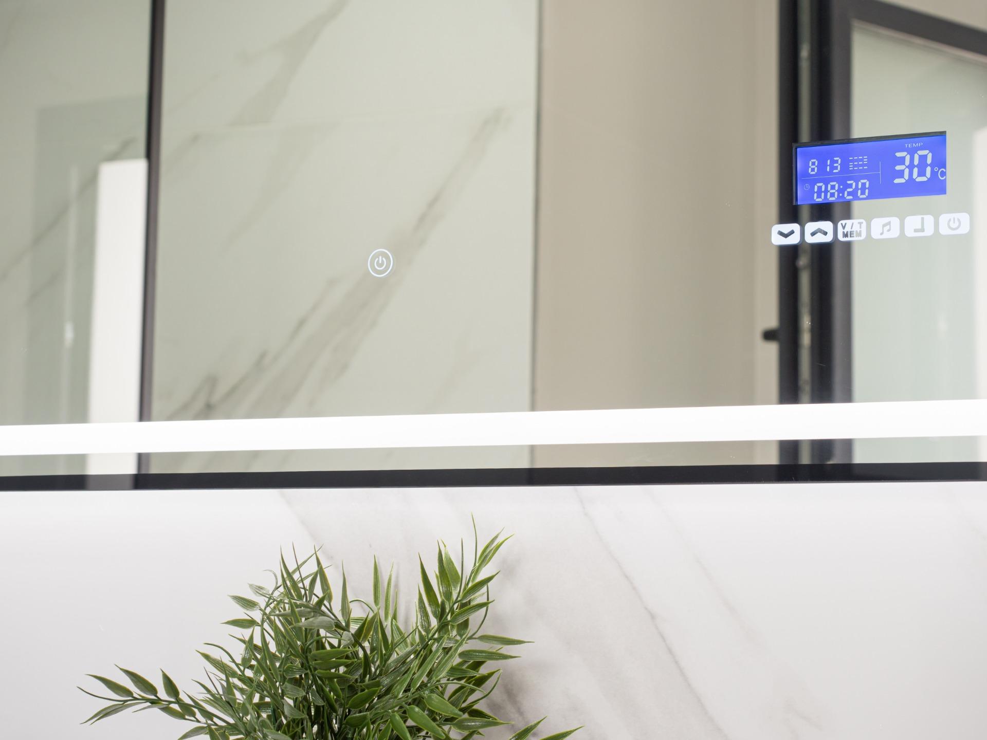 Modern interior with a potted plant, glass panels, and a blue digital thermostat reading 30°C.