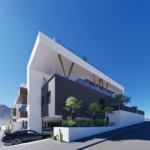 Modern white and gray apartment building with glass balconies and palm trees against a clear blue sky.