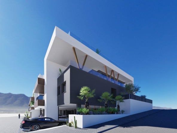Modern white and gray apartment building with glass balconies and palm trees against a clear blue sky.