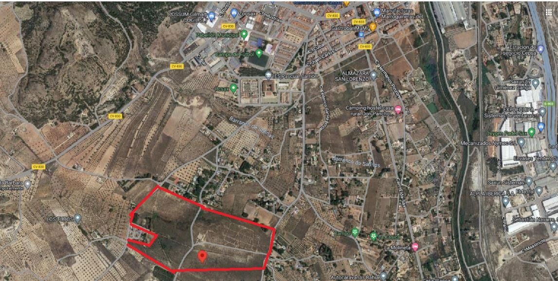 Satellite map highlighting a land parcel outlined in red with a pin marking its location in the southern area.