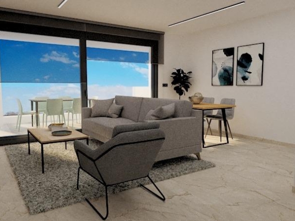 Bright, modern living room with gray sofa and armchair, glass balcony doors, and a dining table visible beyond the seating area.