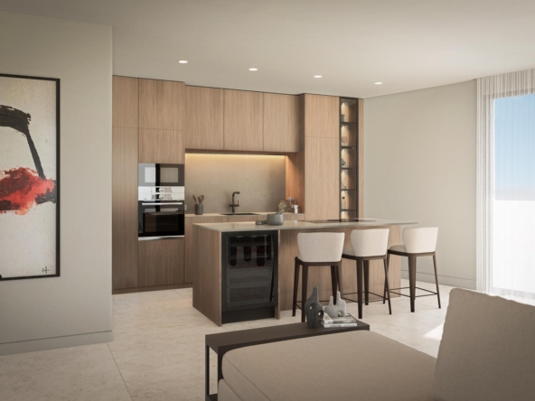 Open-plan kitchen with warm wood cabinetry, an island with bar seating, and built-in oven area under soft ceiling lighting.