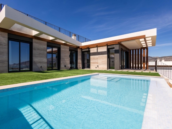Modern villa with large glass doors, wooden beams, and a rectangular blue-tiled pool in the yard. Suitable for a luxury home exterior image.