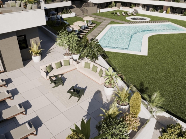 Aerial view of a modern resort pool area with a rectangular pool, circular hot tub, loungers under umbrellas, and surrounding greenery.