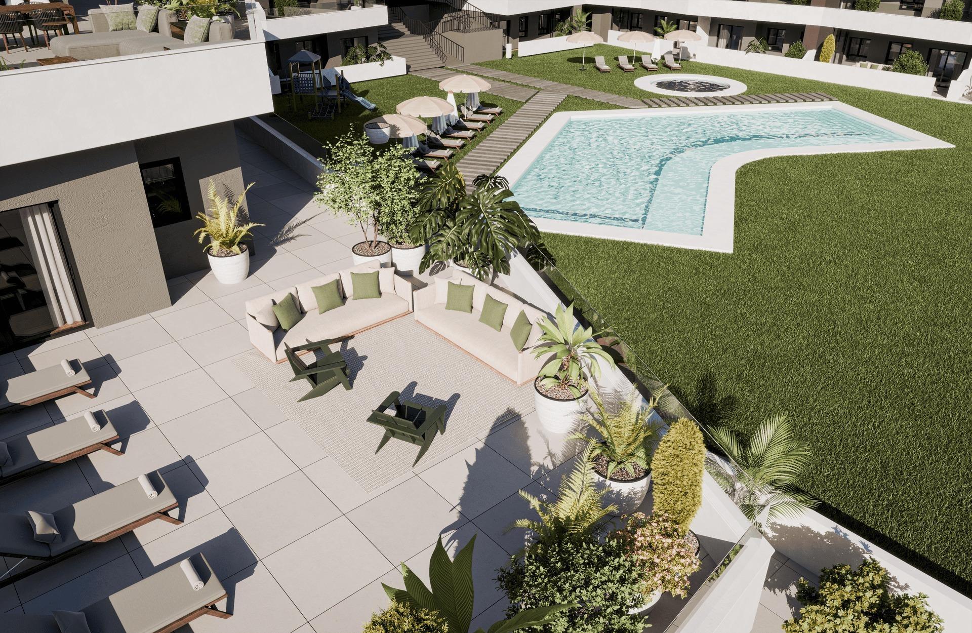Aerial view of a modern resort pool area with a rectangular pool, circular hot tub, loungers under umbrellas, and surrounding greenery.
