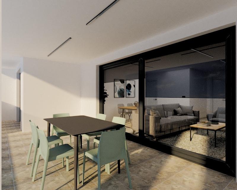 Outdoor patio with a square dark table and six pastel mint chairs; glass doors lead to a living room with a gray sofa and coffee table behind.