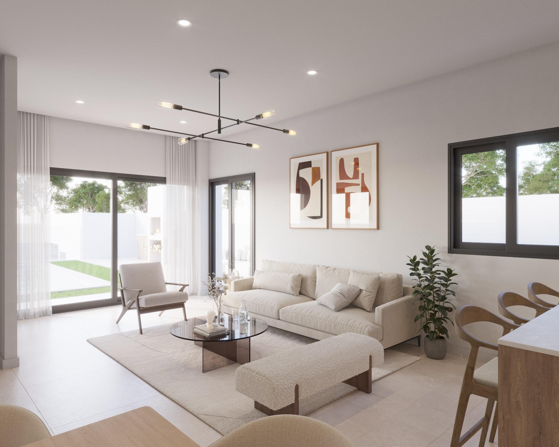 Bright open-concept living room with neutral furniture, abstract framed art, and large windows letting in natural light.