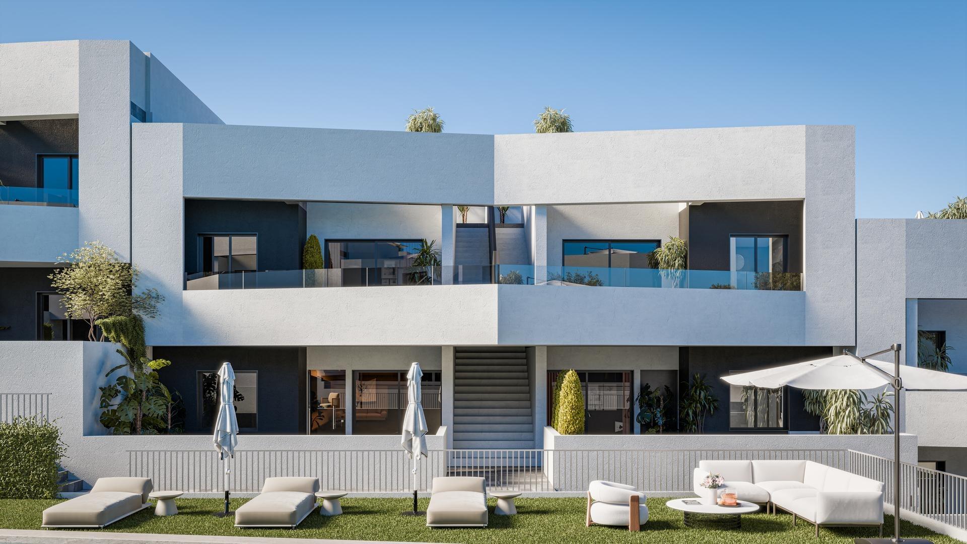 Contemporary white and gray apartment building with glass balconies against a blue sky and palm trees on the roof line.