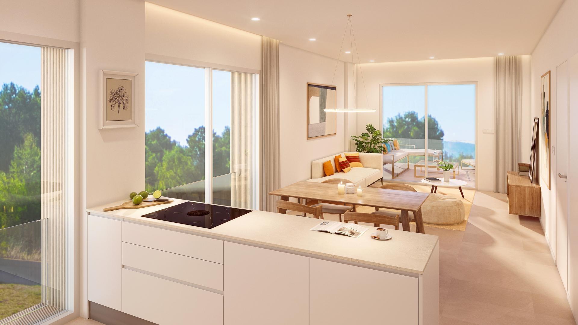 Open-plan kitchen and living area with white cabinetry, wood dining table, and large glass doors opening to a balcony. Reassuring bright and airy space.