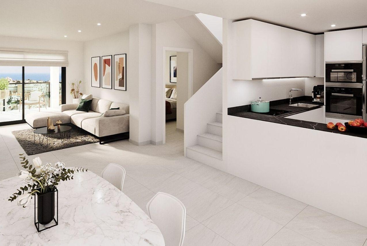 Open-plan living area showing a beige sectional sofa, coffee table, and wall art, with sliding doors to a balcony and city view beyond.
