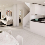 Open-plan living area showing a beige sectional sofa, coffee table, and wall art, with sliding doors to a balcony and city view beyond.