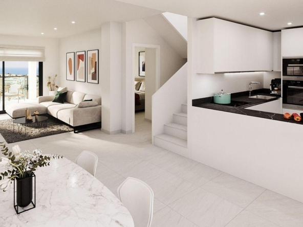 Open-plan living area showing a beige sectional sofa, coffee table, and wall art, with sliding doors to a balcony and city view beyond.