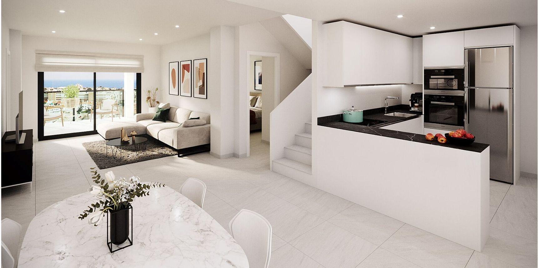 Open-plan living area showing a beige sectional sofa, coffee table, and wall art, with sliding doors to a balcony and city view beyond.
