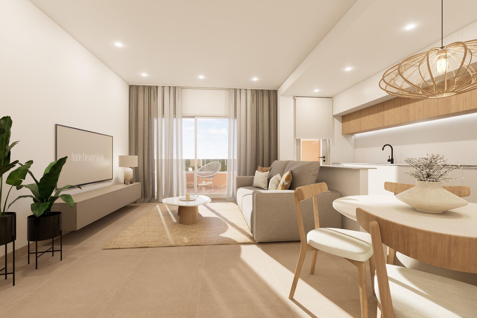 Bright open-plan living area and kitchen with beige sofa, coffee table, and balcony view through glass doors.