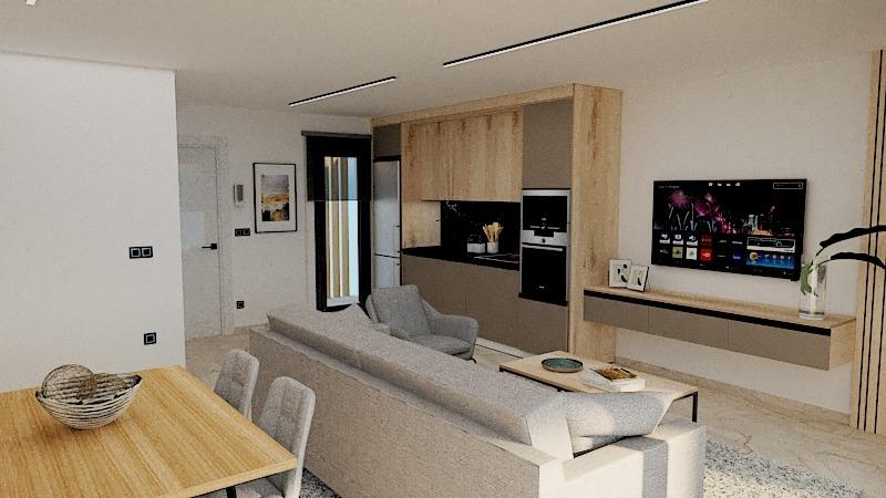 Open-concept living area with a dining table, gray sofa, and a wall-mounted TV above a floating cabinet; kitchen in the background with tall wooden cabinets.