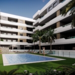 Modern white apartment building surrounding a courtyard pool with palm trees and lounge chairs by the water's edge.