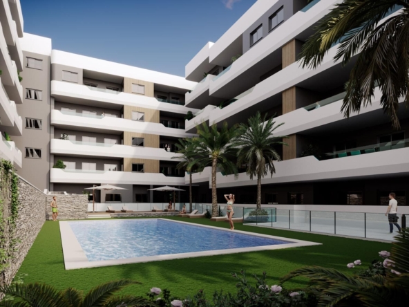 Modern white apartment building surrounding a courtyard pool with palm trees and lounge chairs by the water's edge.