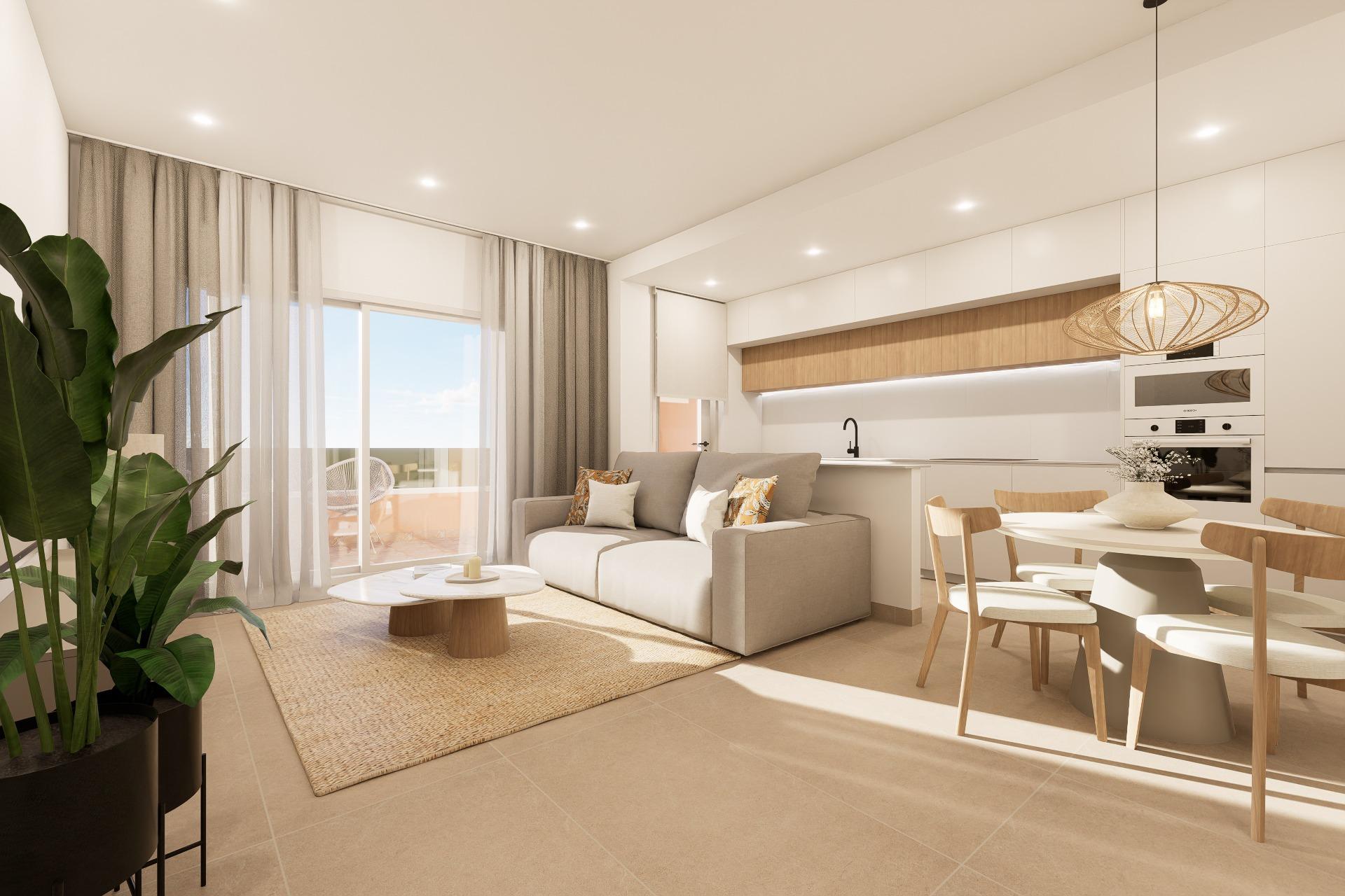 Open-concept living area with a beige sofa, wooden dining table, white kitchen cabinets, and a large potted plant in the foreground.