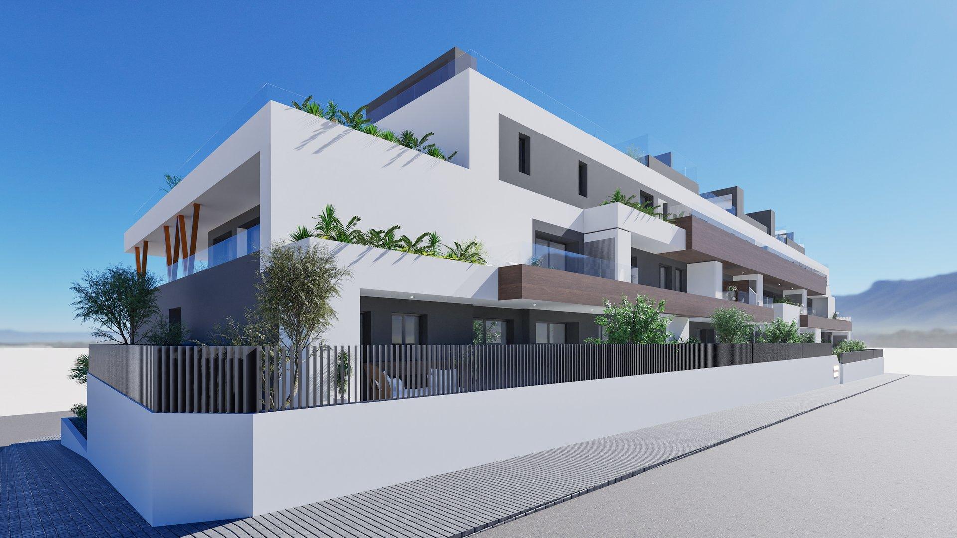 Modern white apartment building with balconies and greenery under a clear blue sky.