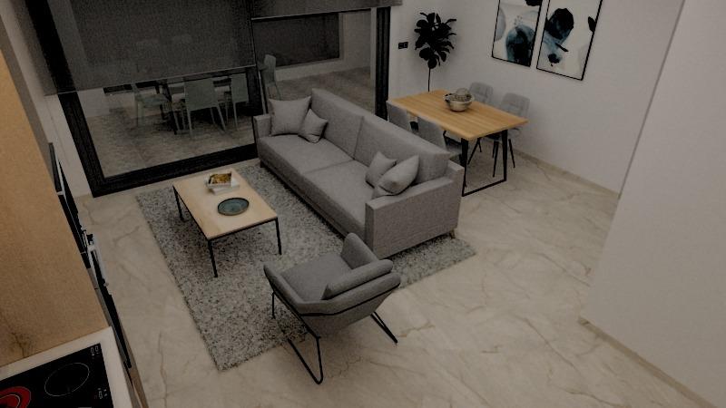 Modern open-plan living room with gray sofa and armchair facing a coffee table and rug, next to a dining area and large glass doors to the outside.