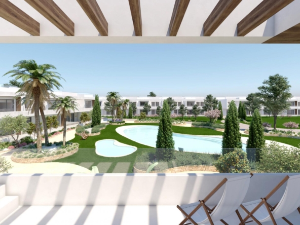 Modern resort courtyard with white low-rise buildings, palm trees, and a winding pool seen from a shaded terrace with wooden beams.