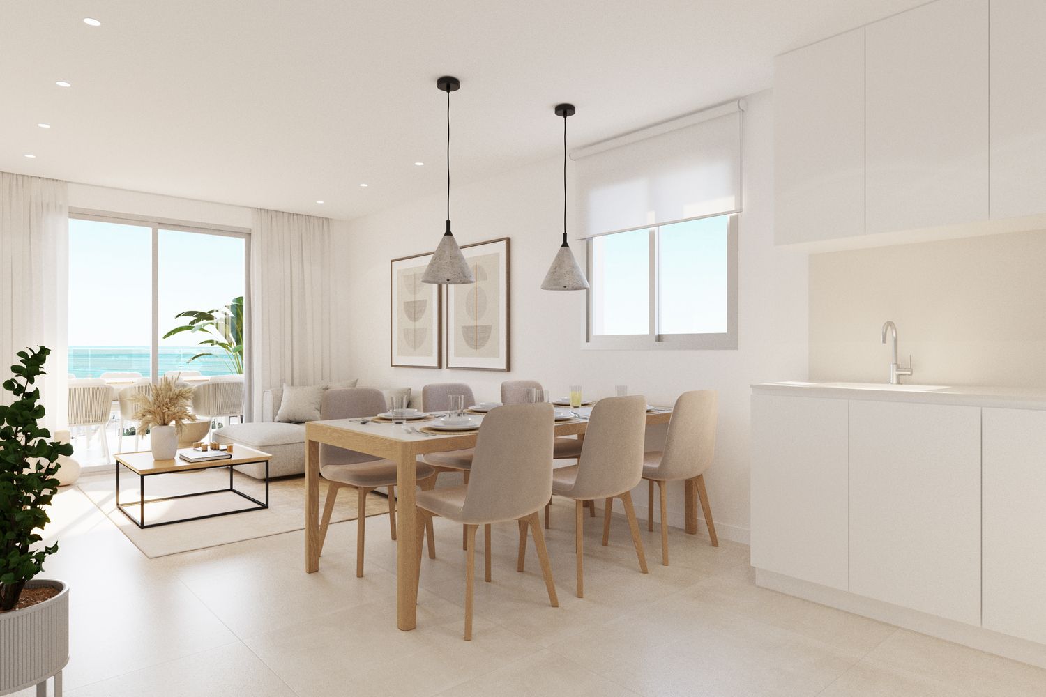 Bright open-plan living, dining, and kitchen area with white walls, light wood furniture, and a sea-view balcony beyond sliding doors.