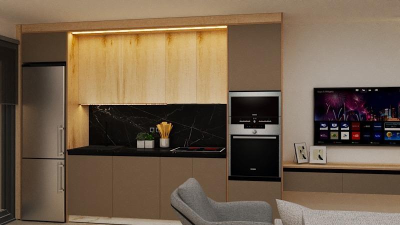 Modern kitchen with pale wood upper cabinets, dark base cabinets, and a black marble backsplash, adjacent stainless fridge and built-in oven. TV and seating visible nearby.
