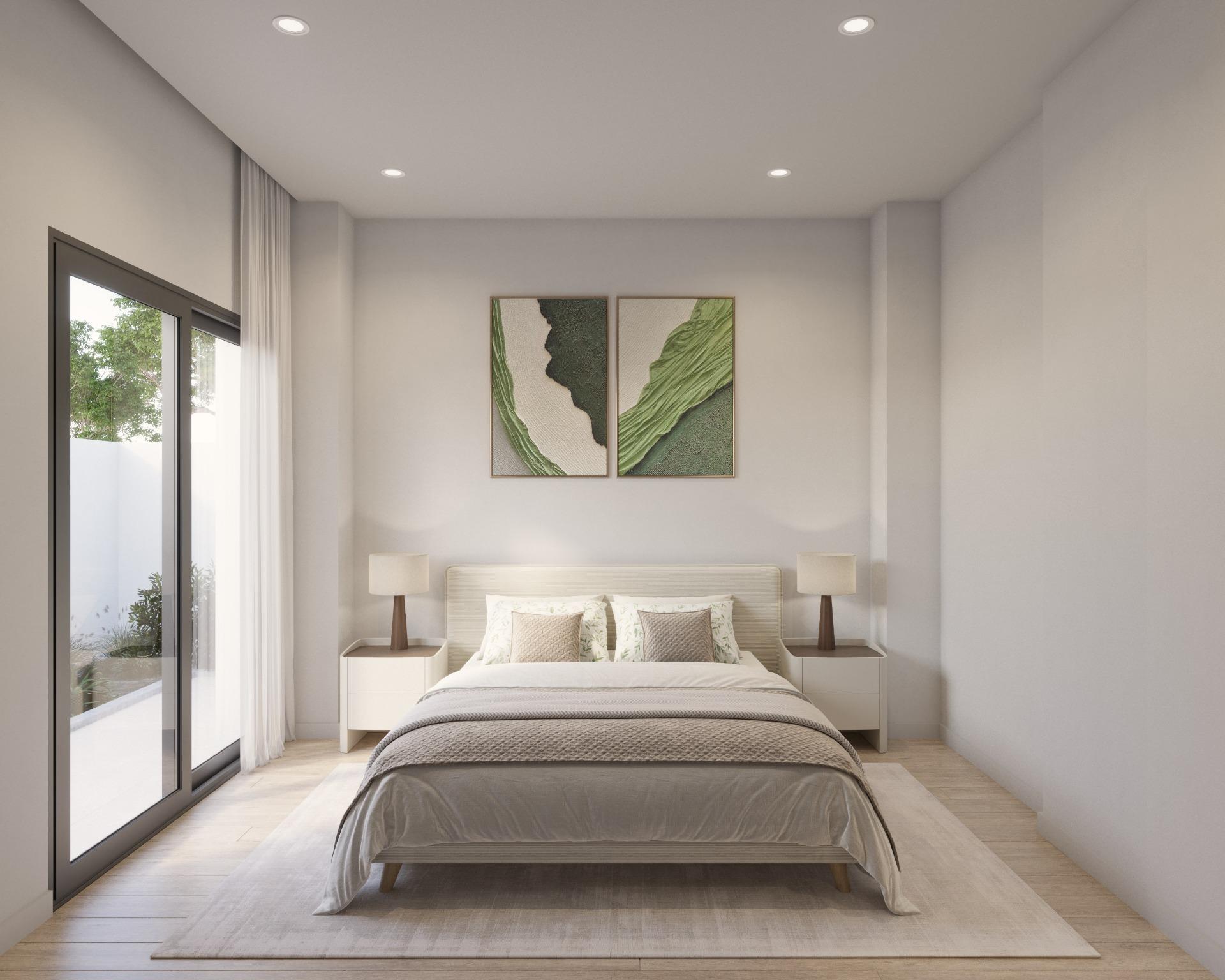 Modern bedroom with a low wooden bed centered on the wall, two matching nightstands with lamps, and a two-panel green abstract artwork above the headboard; large glass sliding doors with sheer curtains on the left opening to outdoors.