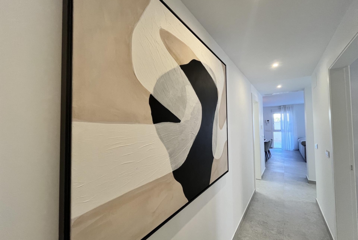 Narrow hallway with a large abstract painting on the left wall in beige, white and black tones.