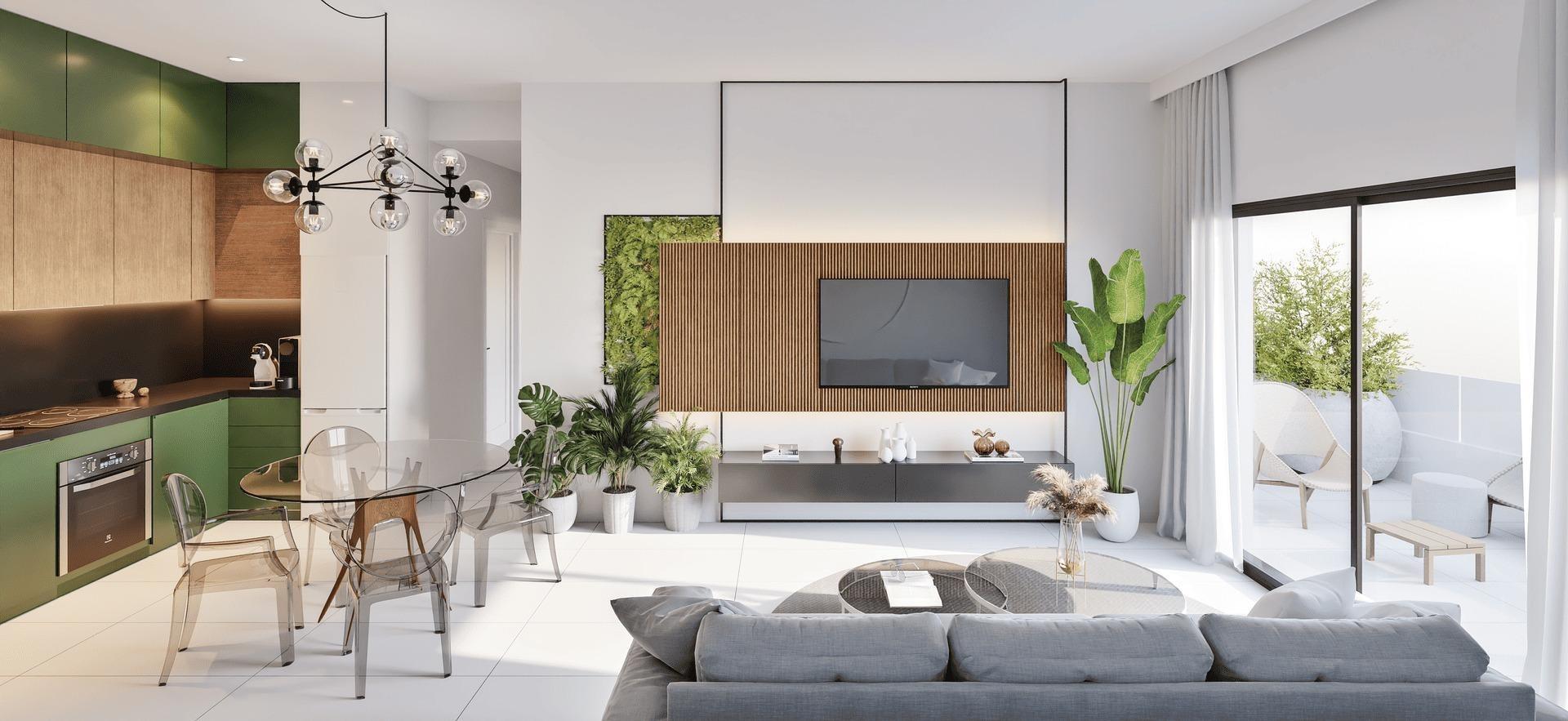 Open-concept living area with green kitchen cabinets, glass dining table, and a wall-mounted TV framed by wood slats; sliding doors open to a balcony.