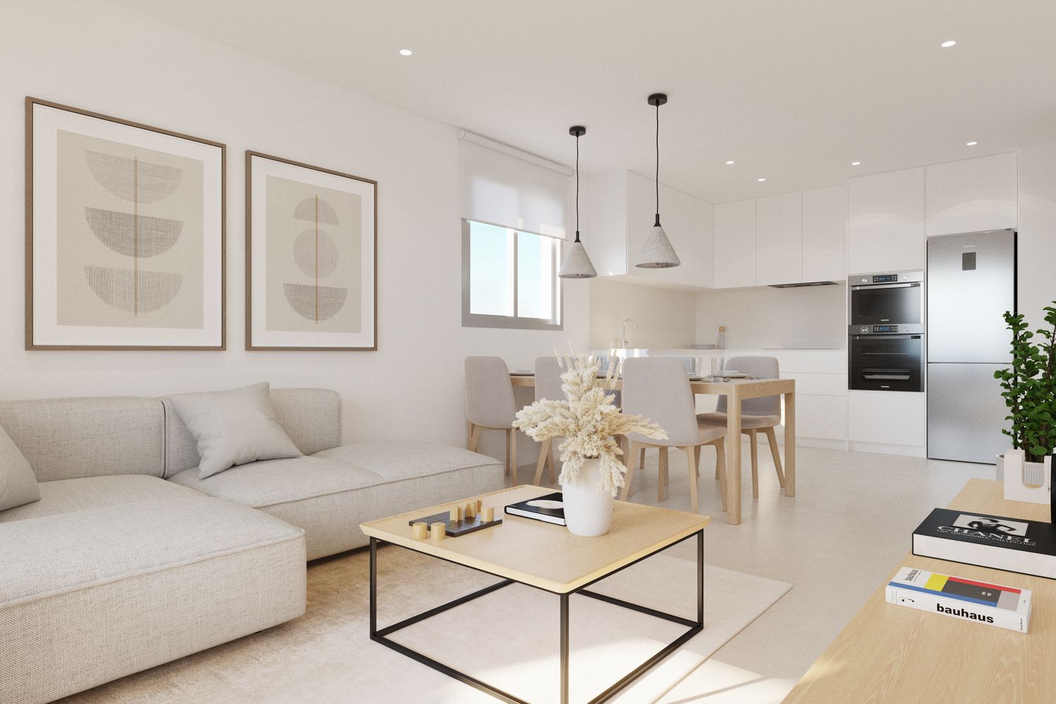 Bright, minimalist open-plan living area with a beige sofa, coffee table, and abstract framed art; dining table nearby and white kitchen in background.
