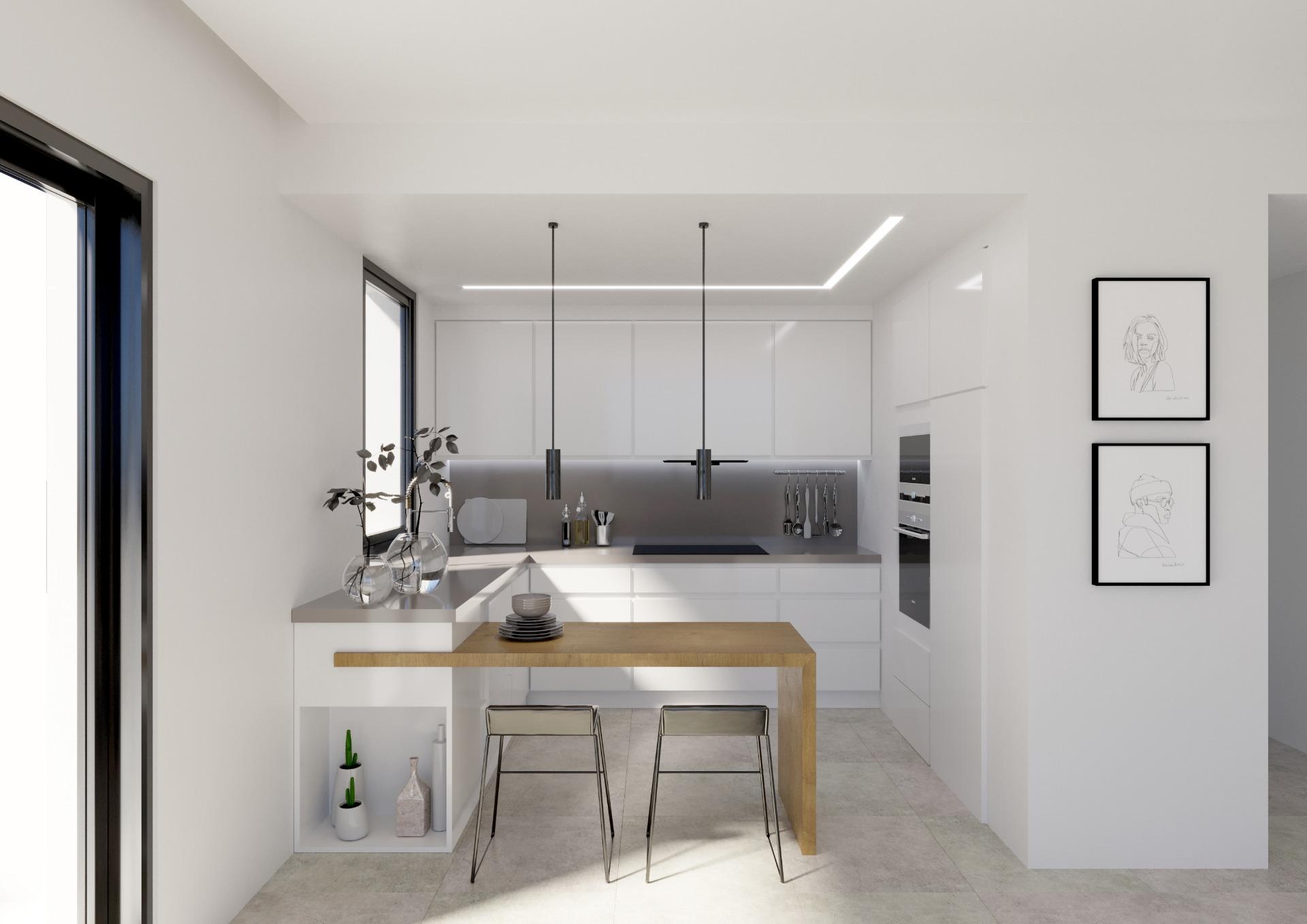 Minimalist white kitchen with an island, two black pendant lights, and a wooden dining extension.