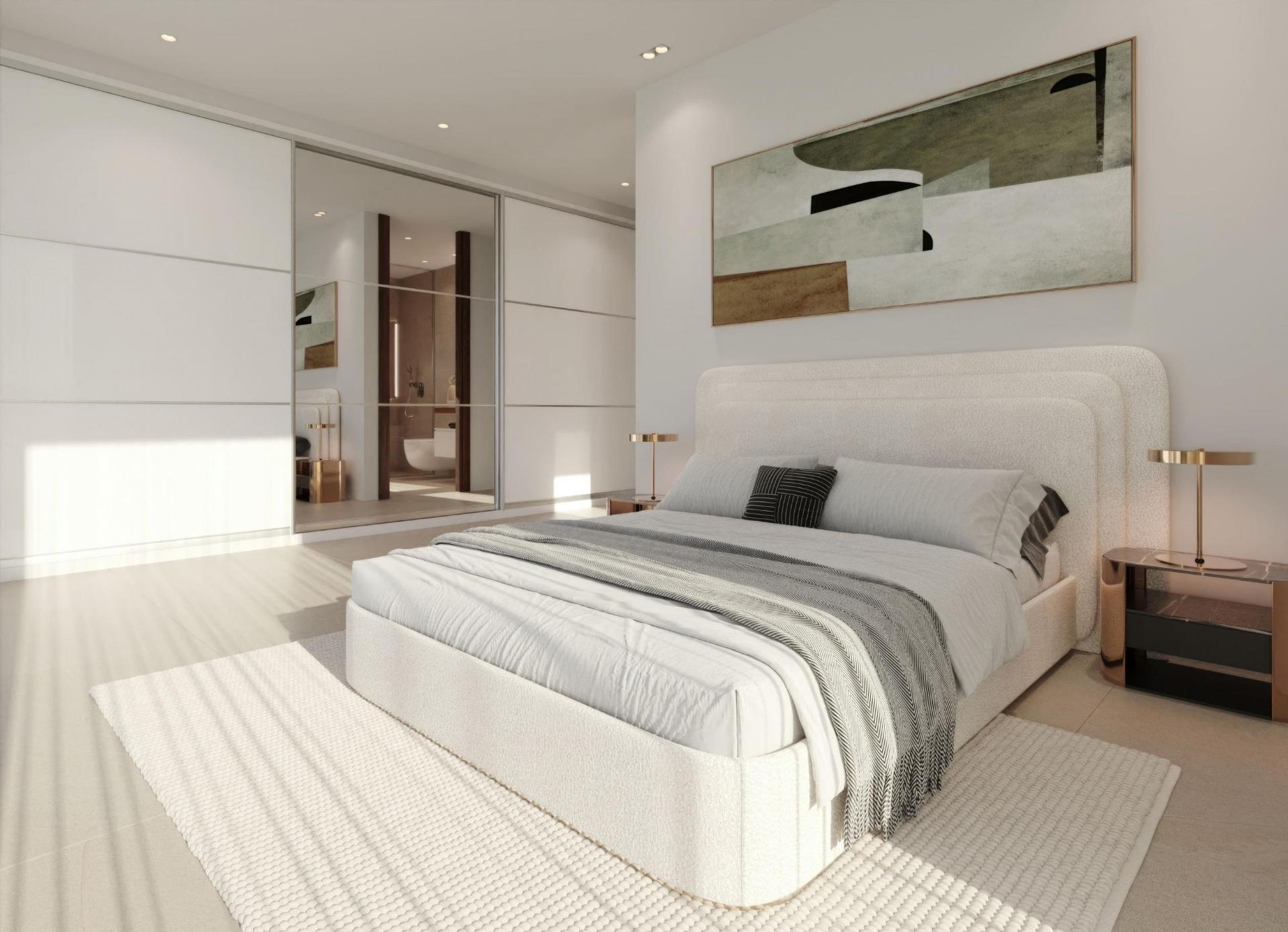 Modern minimalist bedroom with a white upholstered bed, gray striped bedding, and copper bedside lamps on glass tables.