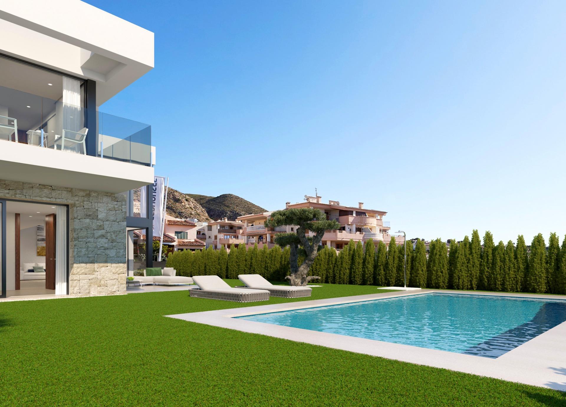 Modern white villa with glass balcony overlooking a rectangular pool, lounge chairs, and a well-kept lawn.