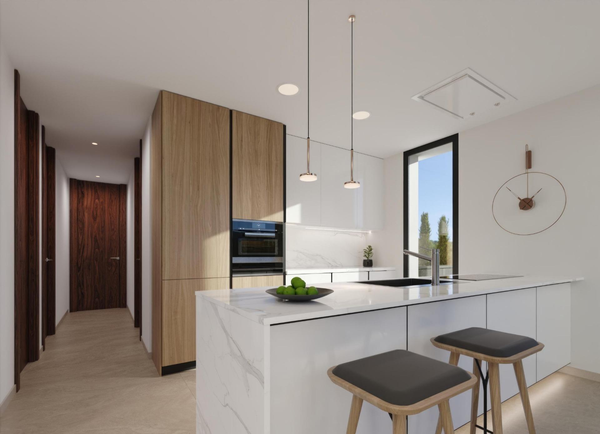 Bright modern kitchen with a white marble island, wood cabinetry, pendant lights, and a hallway with dark wooden doors.