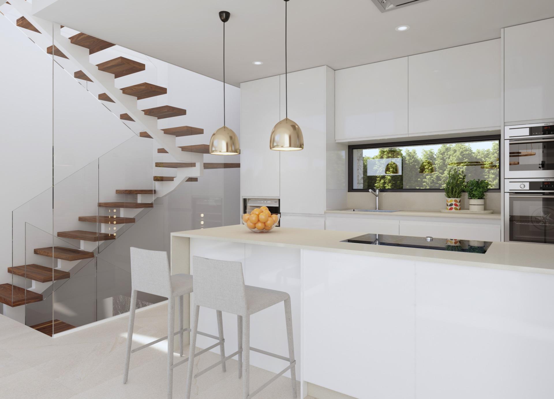 Modern white kitchen with glass-railed wooden staircase and two brass pendant lights over a white island.