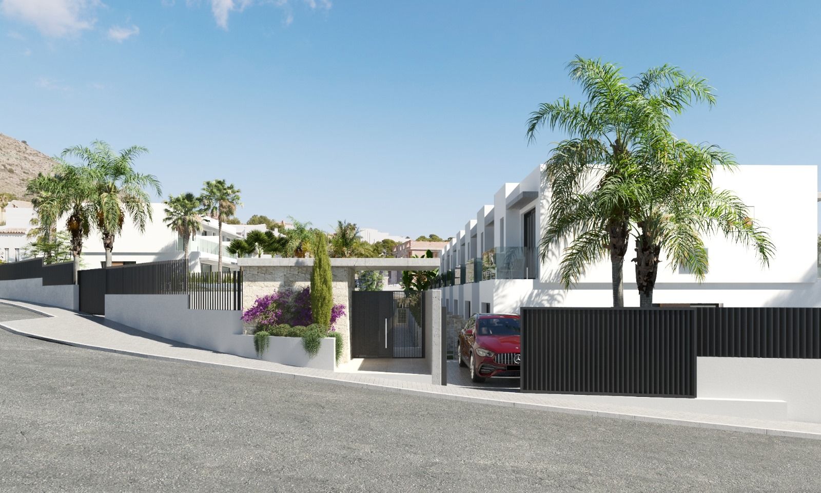 Modern gated residential complex with white cubic buildings, black fences, and palm trees along a curved street; a red SUV is parked near the gate.
