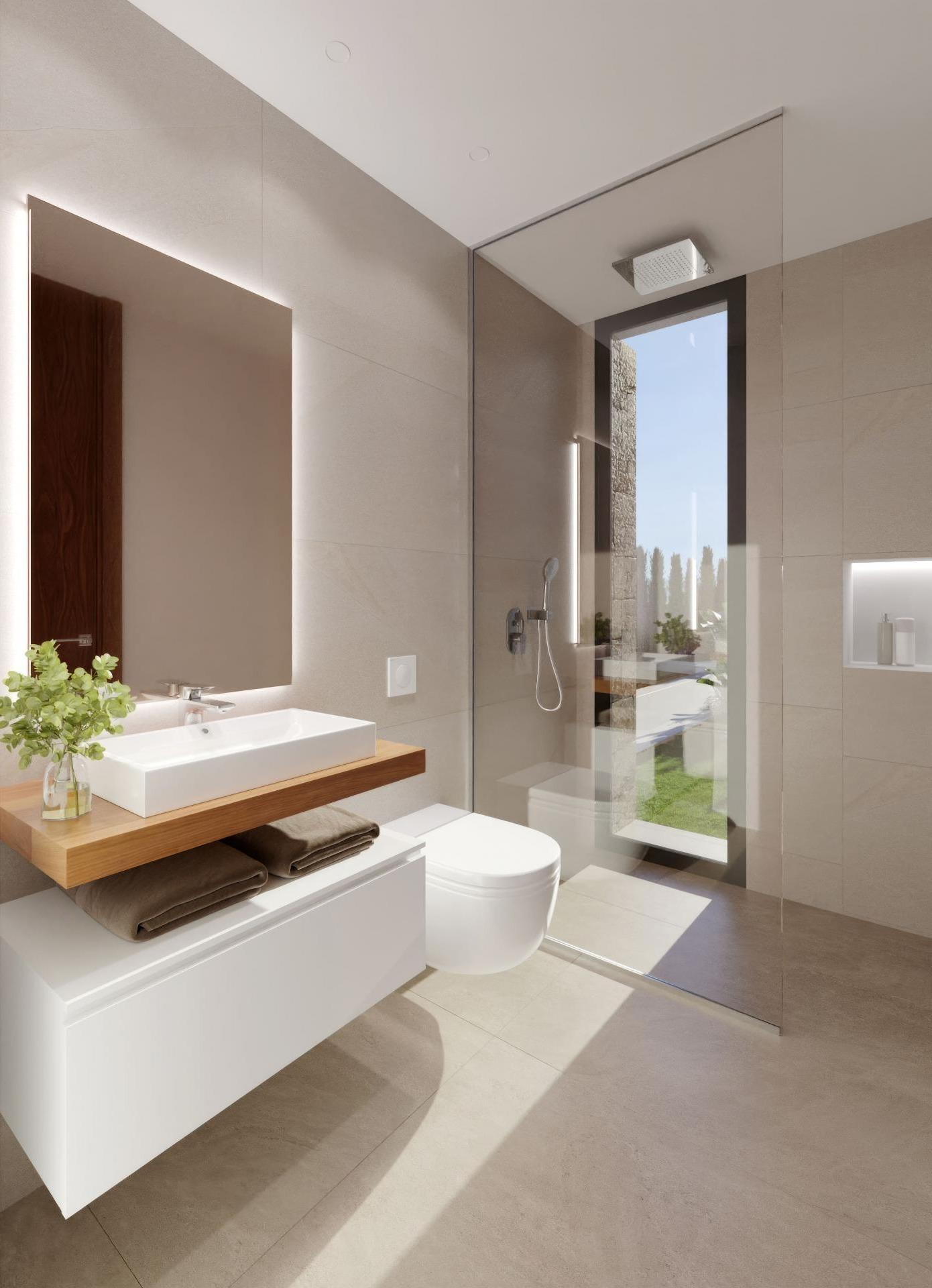 Modern bathroom with glass shower enclosure, wall-mounted sink, and backlit mirror against beige tiles.